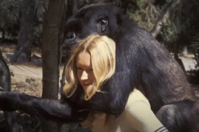 Koko embracing Patterson outdoors