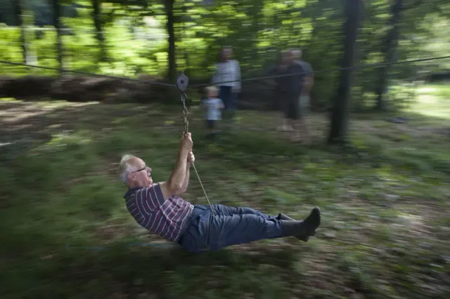 Person on a rope swing in the woods