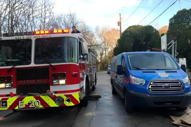 Fire engine parked beside a blue van