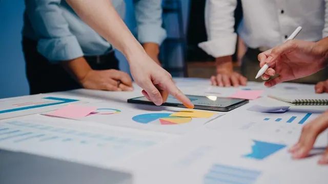People reviewing documents around a table