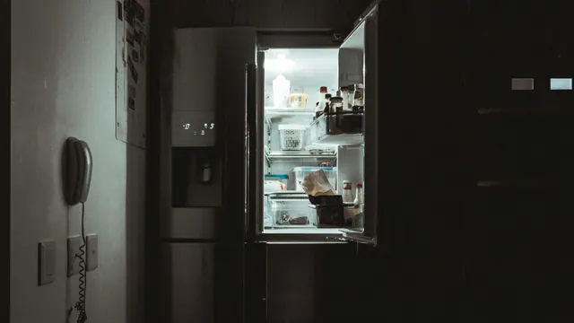 An open refrigerator in a dark room