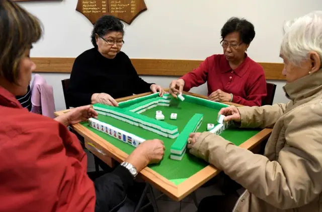 Group playing a tile game