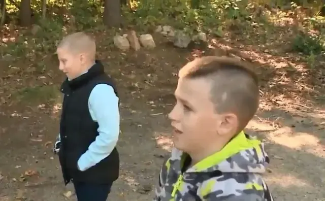 Landin and another child standing outside