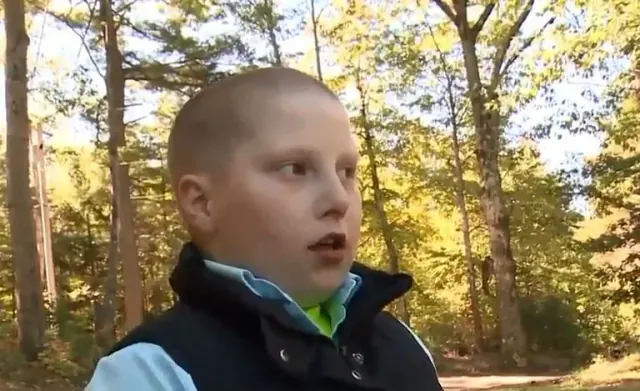 Landin speaking with trees behind him