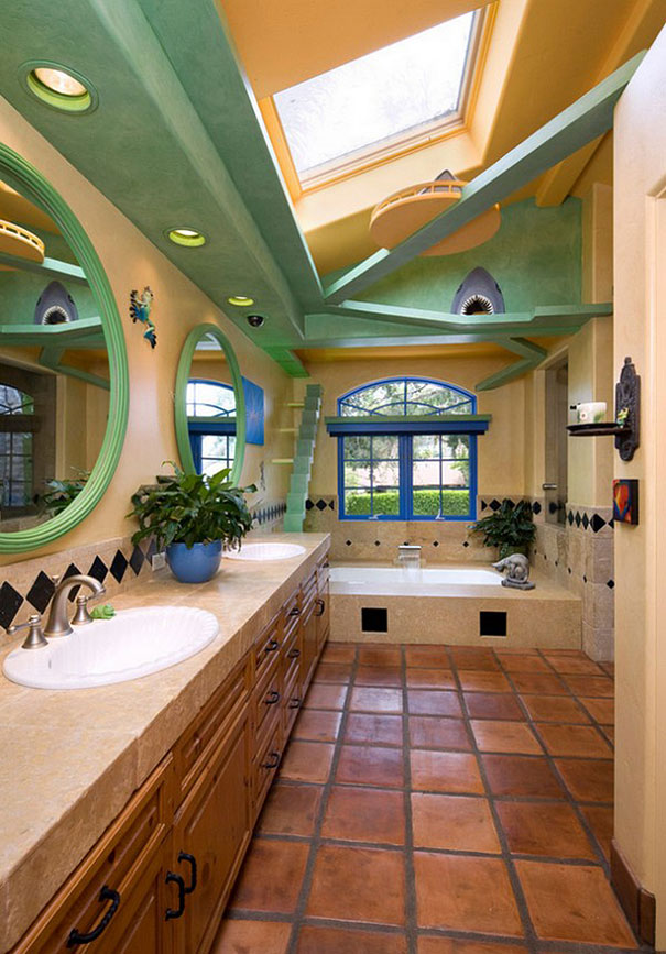 Bathroom with green overhead catwalks, a round mirror, and a skylight.