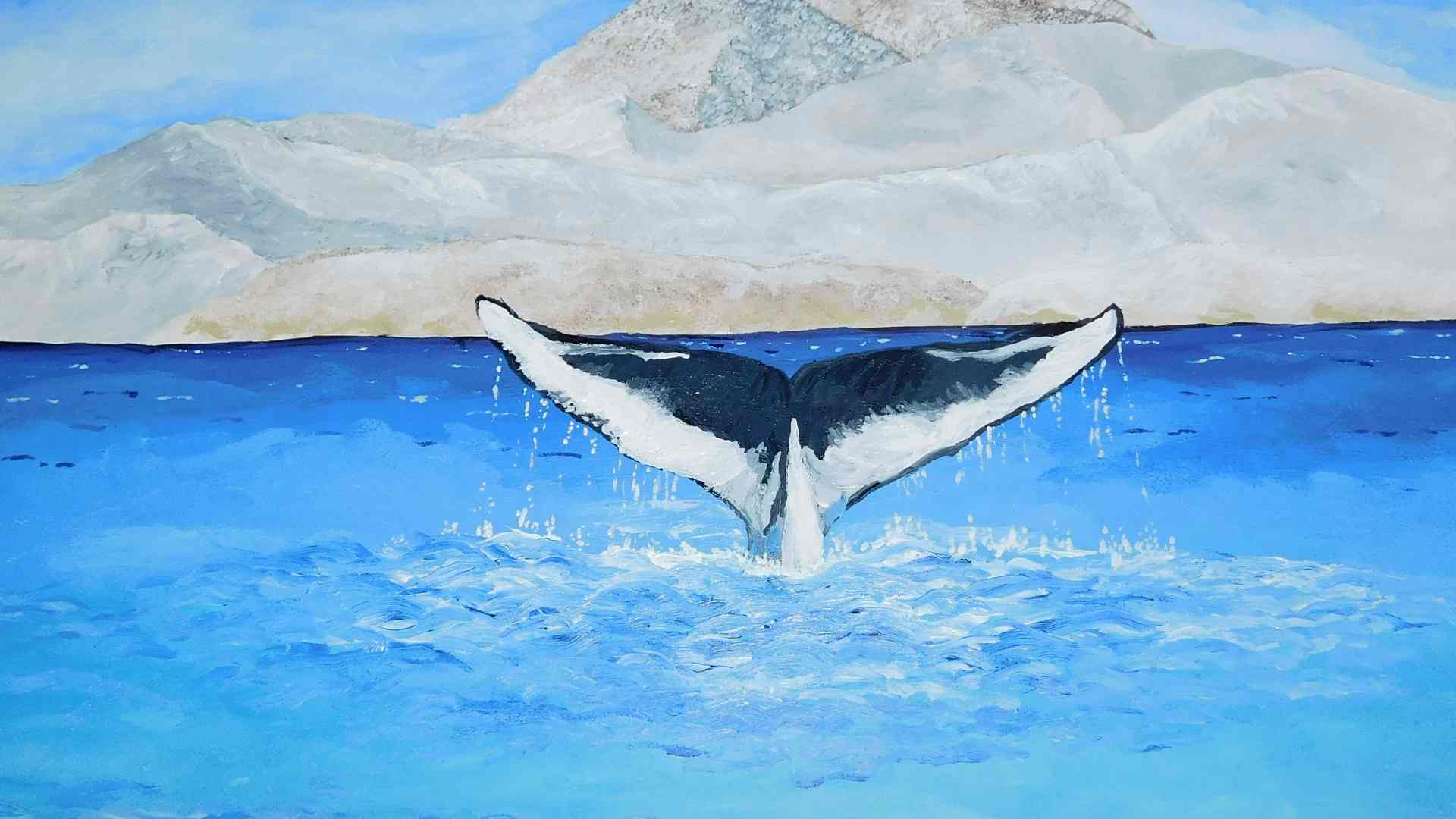 Illustrative whale-tail photograph against mountains.