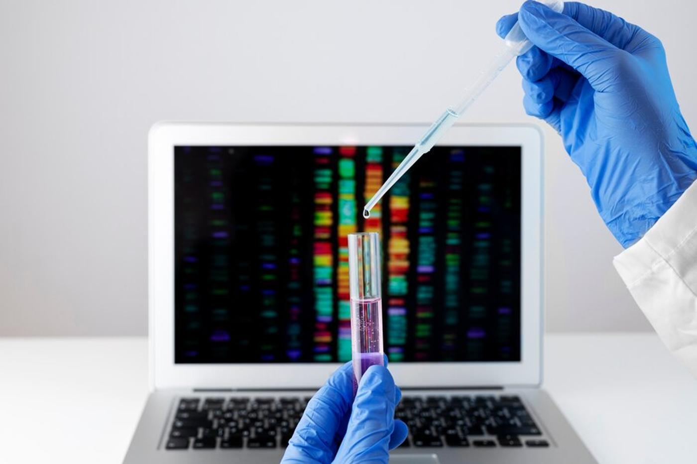 Illustrative laboratory photograph with a pipette and computer.