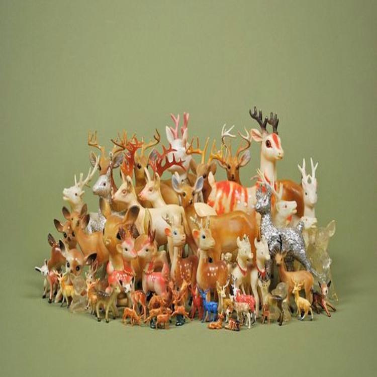 An illustrative collection of small deer figurines.