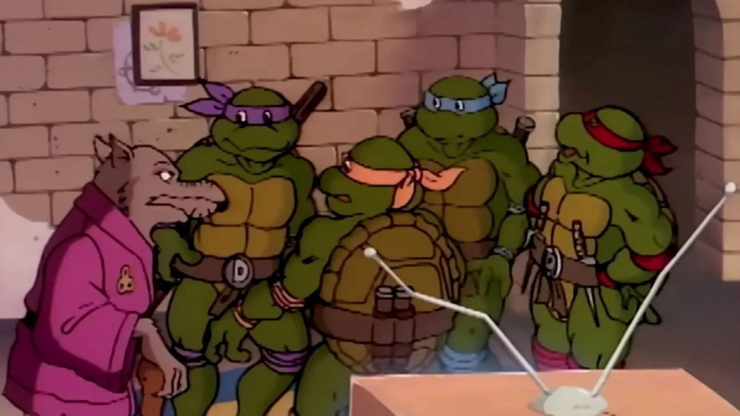 A scene from the animated series "Teenage Mutant Ninja Turtles," featuring the turtles and their master, Splinter, in a room