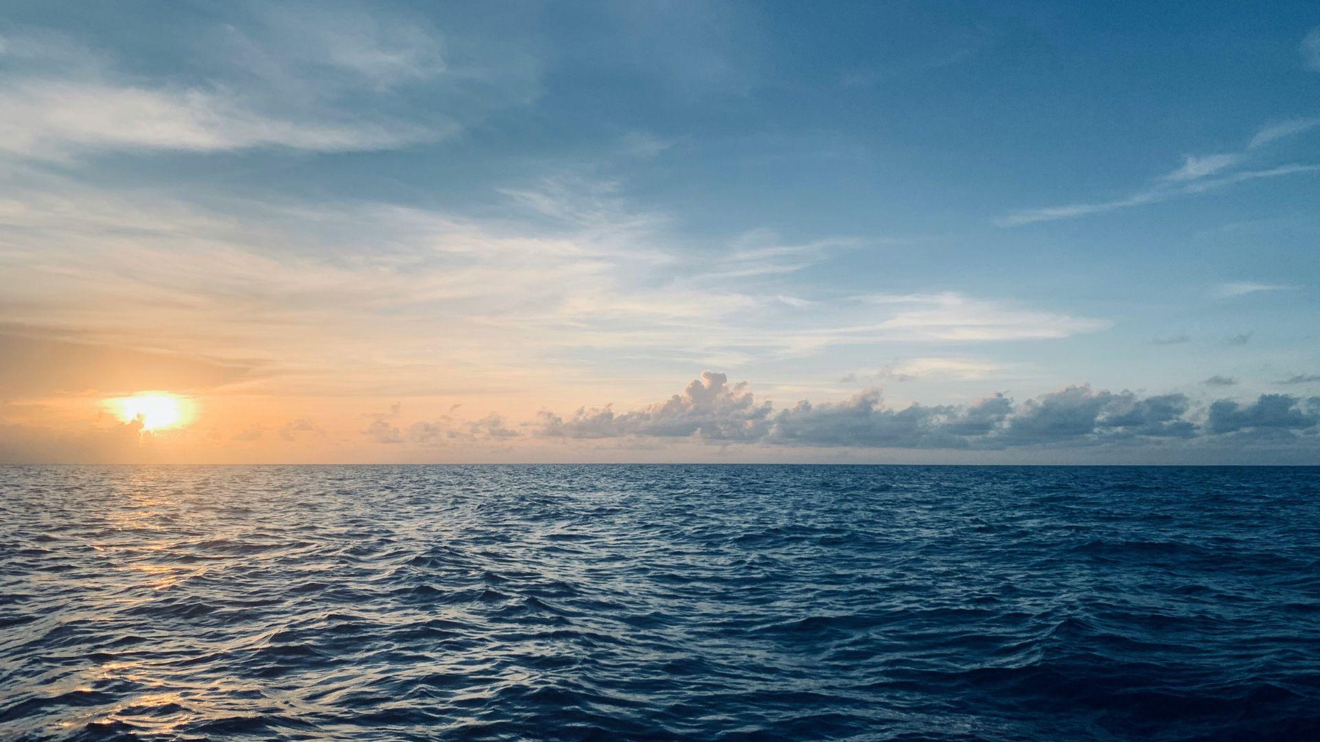 Illustrative photograph of open ocean at sunset.