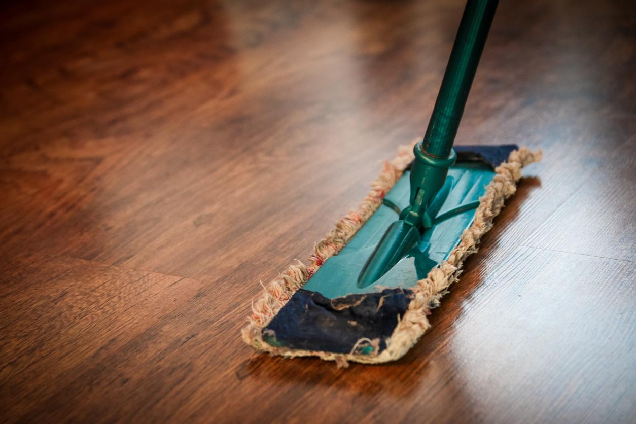 A flat mop on a wooden floor