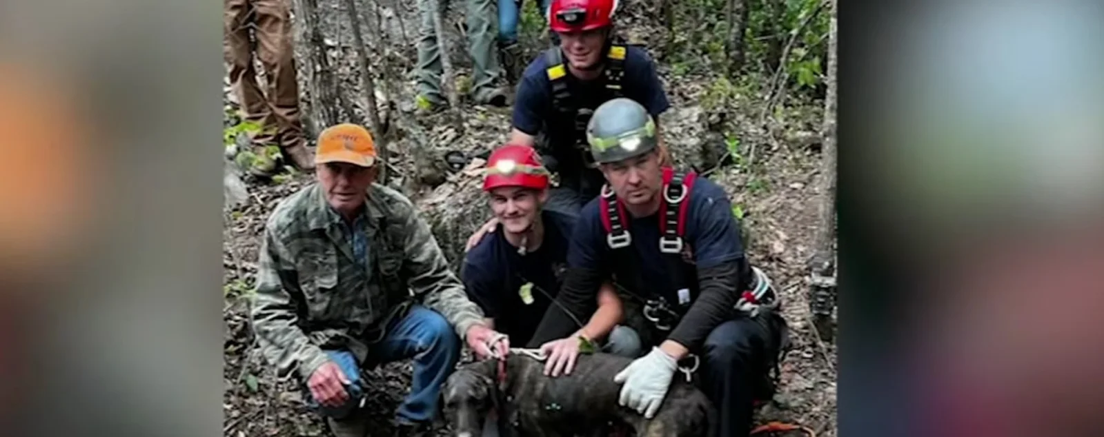 Group of firefighters pose with the dog they recently rescued