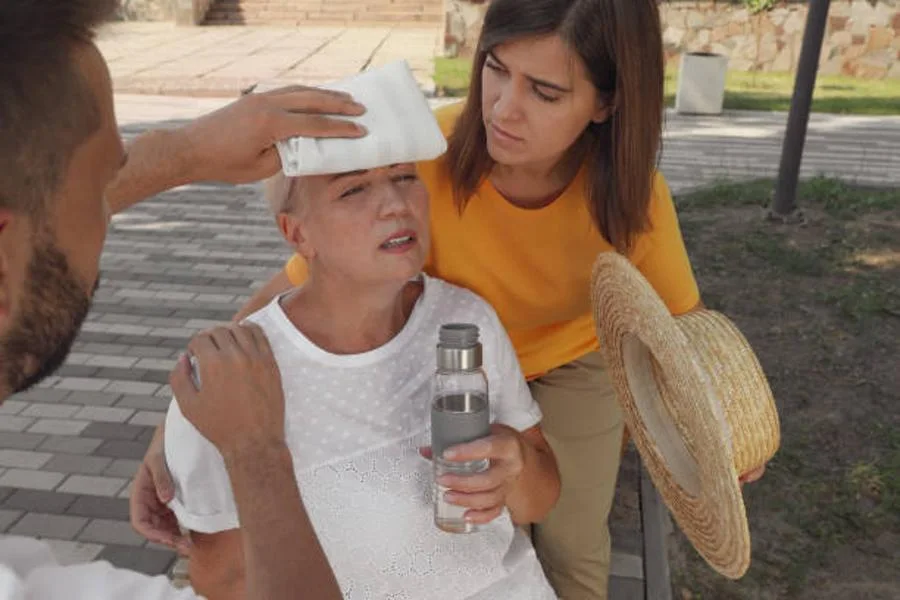Woman experiencing heat stroke is comforted by two others