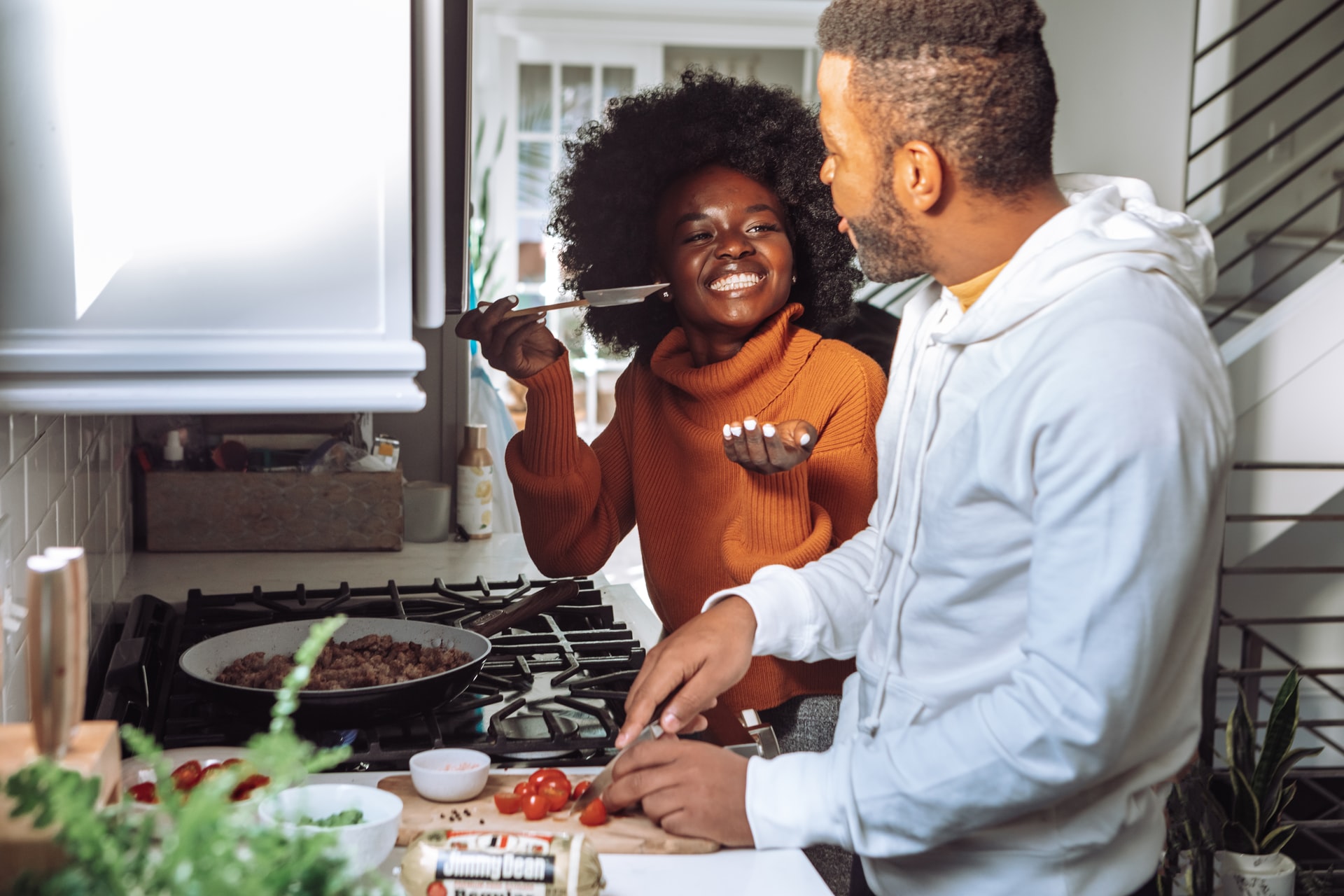 Two people preparing food together in a kitchen