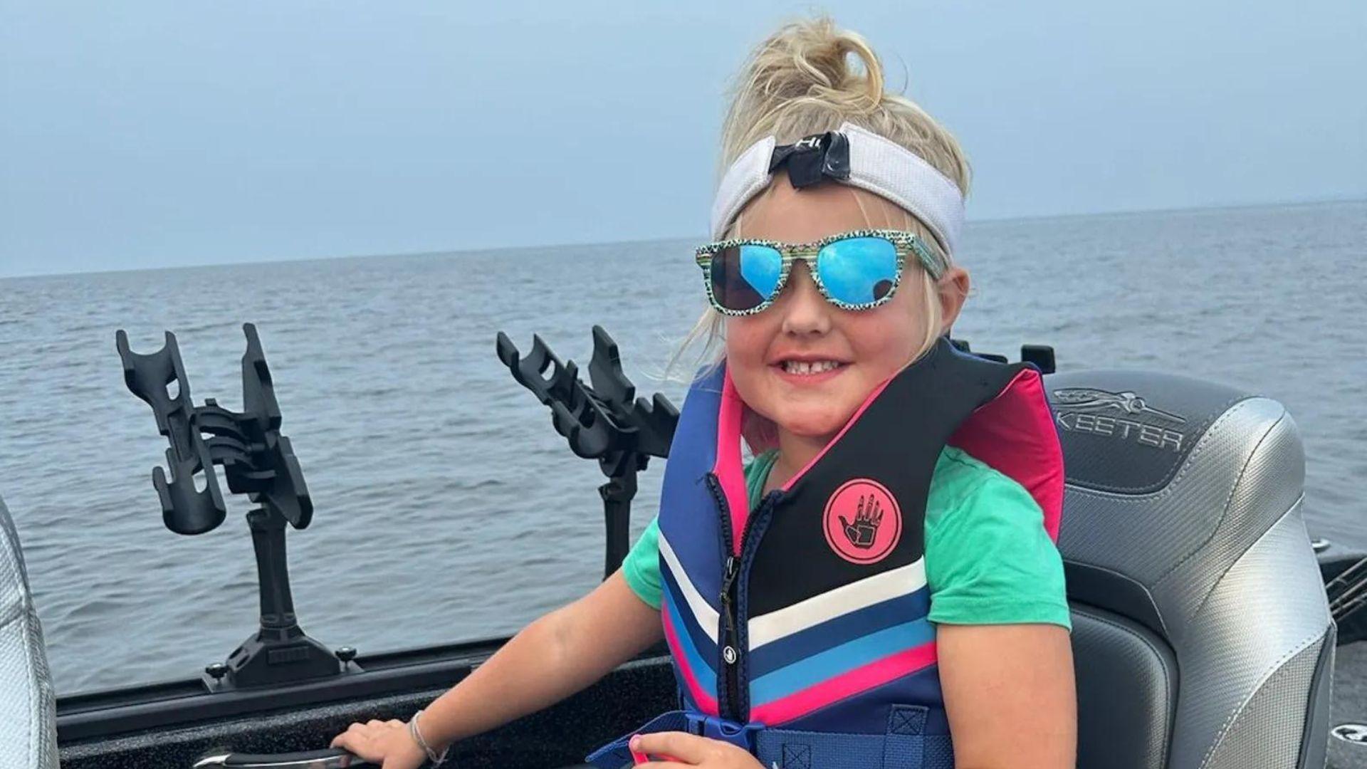 Henley Wollak in a life jacket and sunglasses aboard a boat.