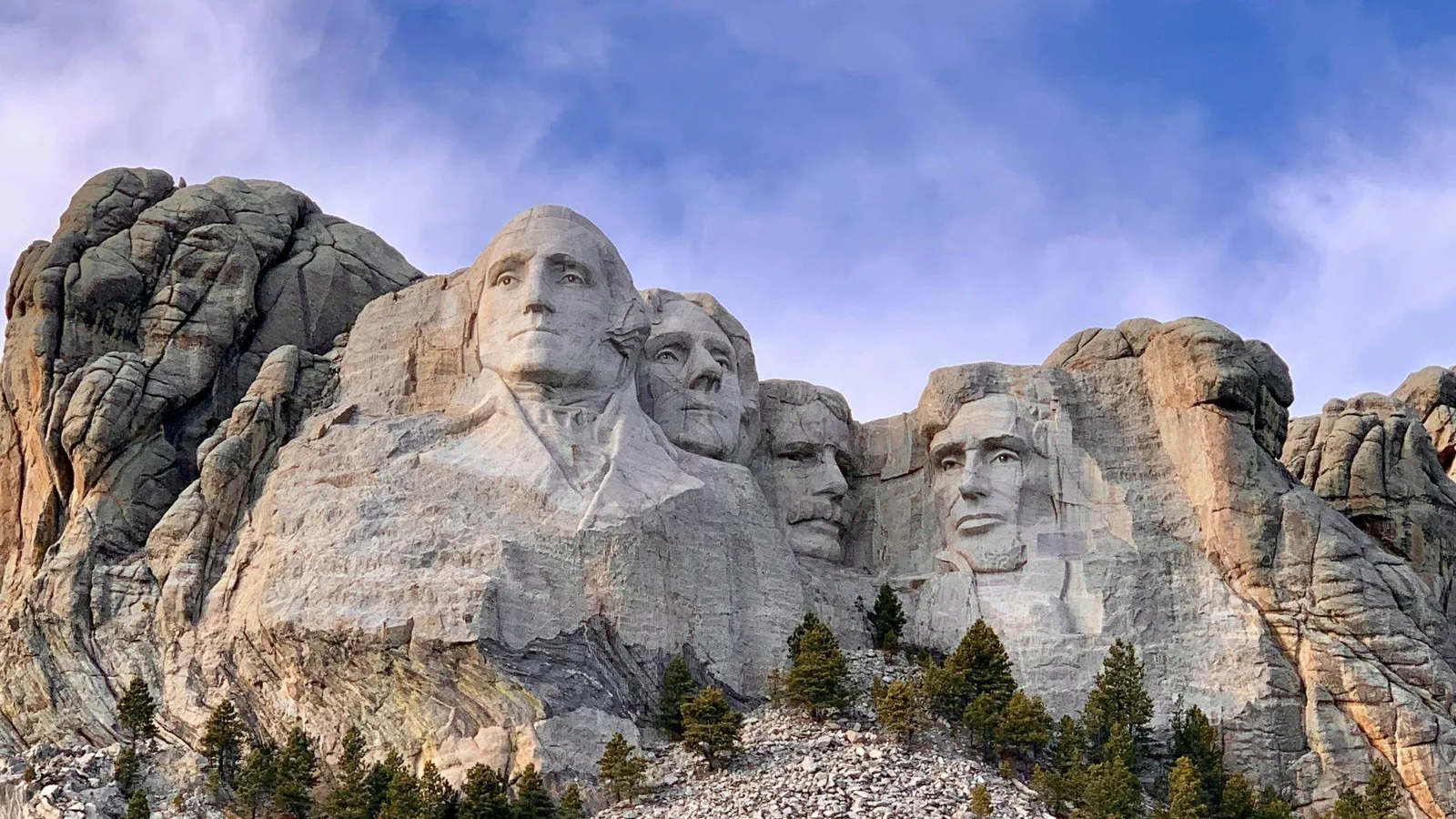 A photograph of Mount Rushmore showing the carved faces of four former U.S. Presidents: George Washington, Thomas Jefferson, Theodore Roosevelt, and Abraham Lincoln