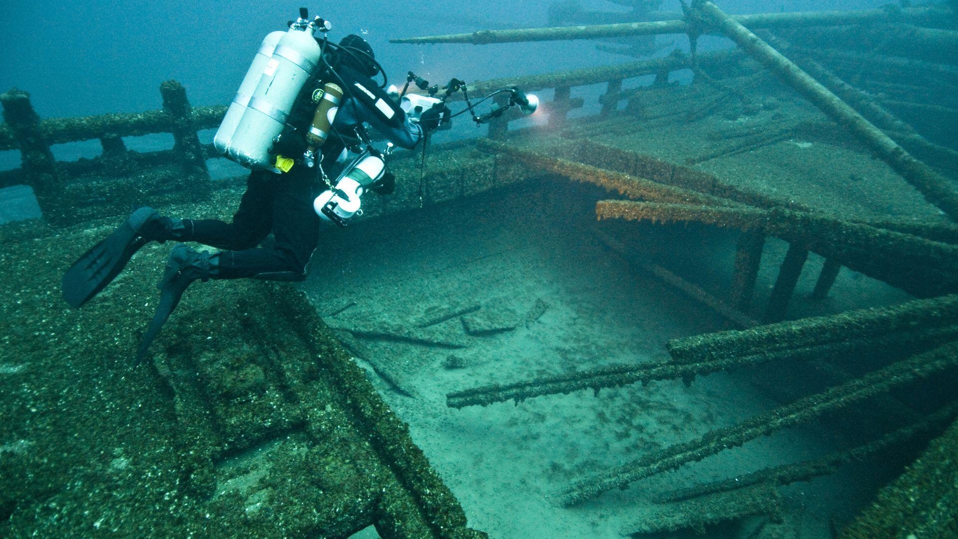 Illustrative photograph of a diver beside another wreck.