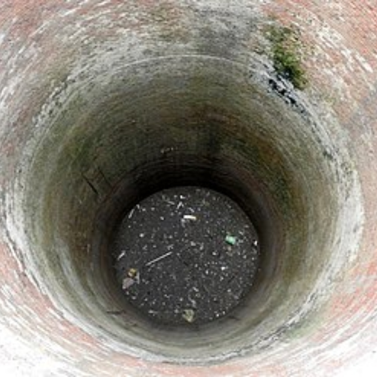 An archive view down a brick-lined well.