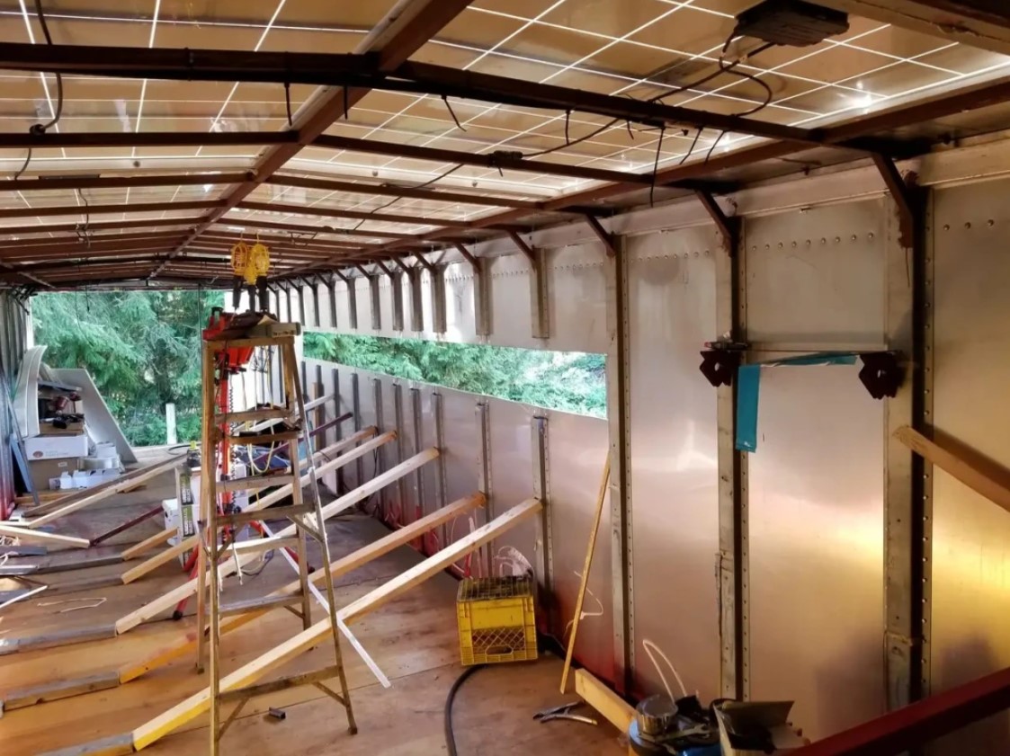 The interior of a trailer during construction, with framing and exposed walls.