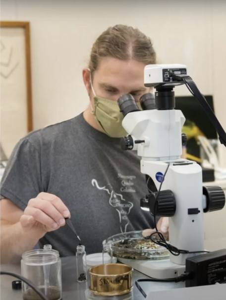 A microscope examination shown in a source video still