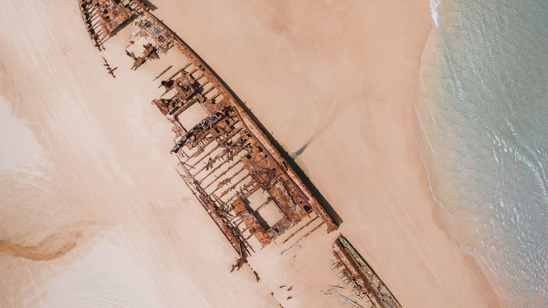 Illustrative overhead photograph of a wreck on a beach.