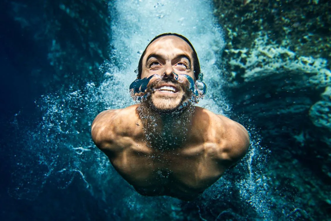 Man tries to get to the surface of the water in Sao Miguel, Portugal