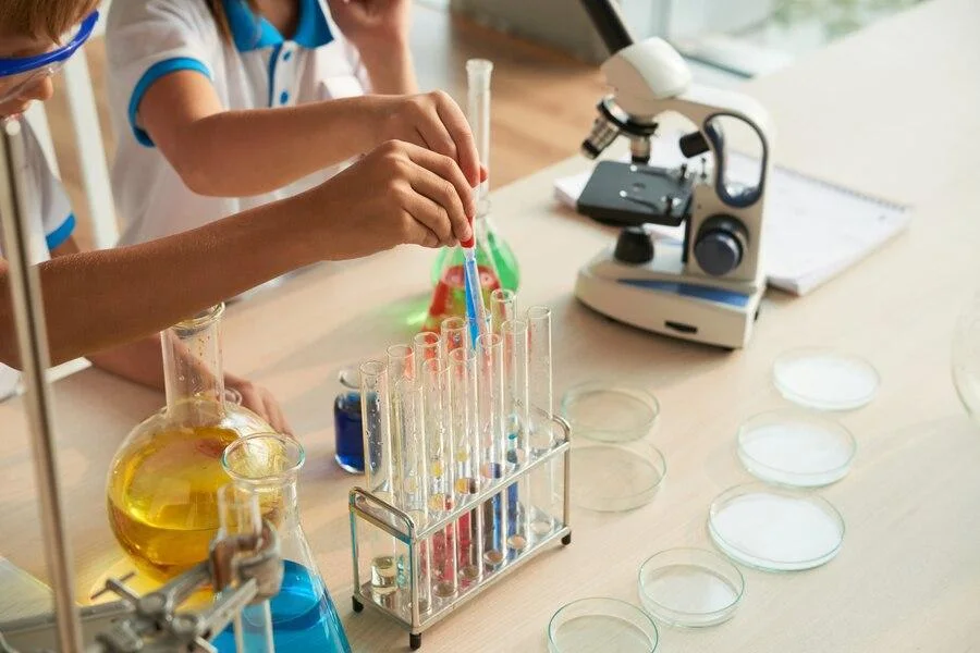 Children using science equipment in a school laboratory