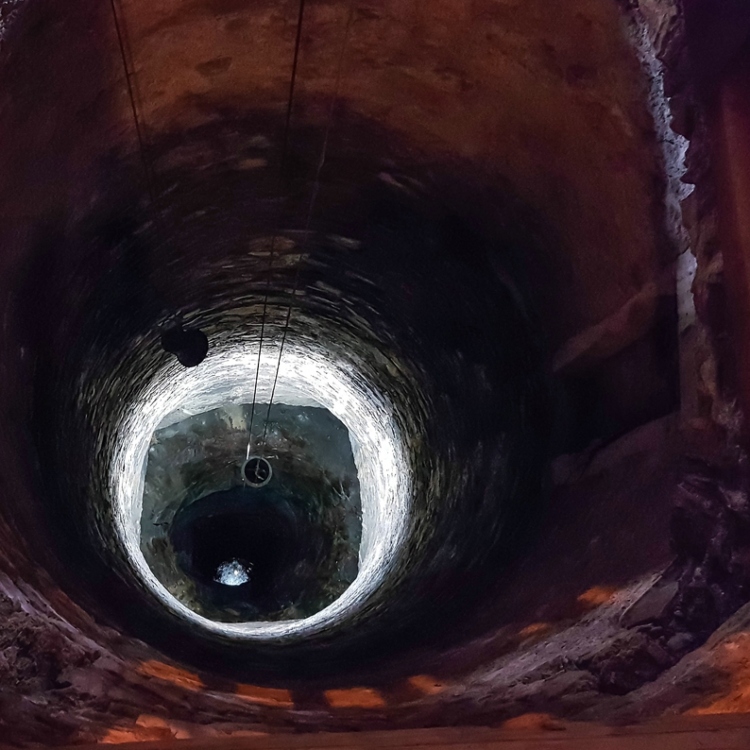 An archive view down an illuminated well shaft.