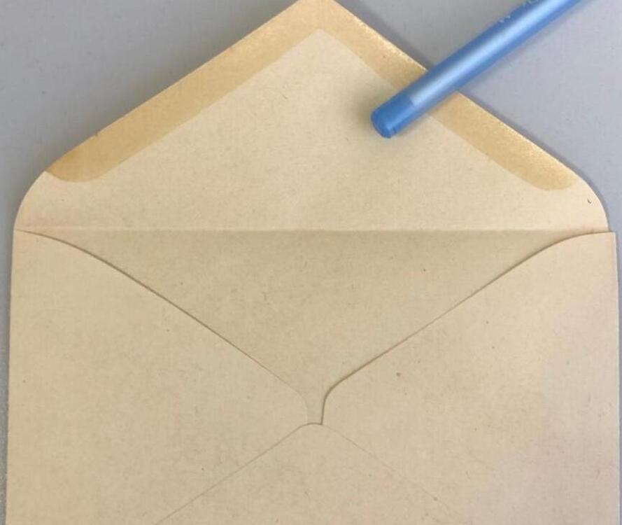 An open envelope beside a pencil.