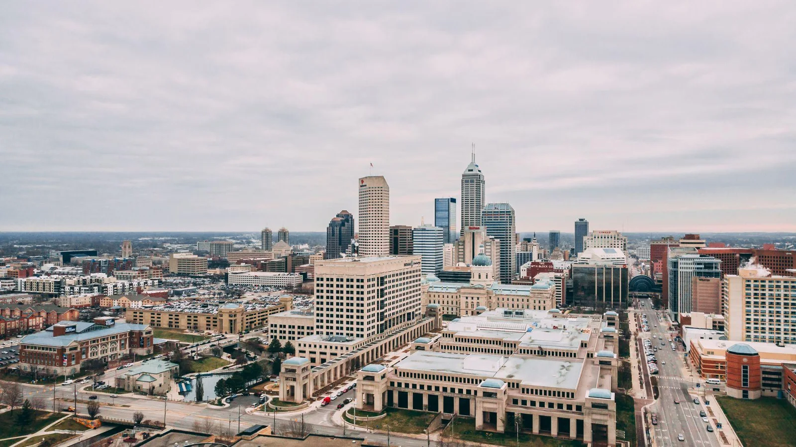 An aerial photograph capturing a wide view of downtown Indianapolis, with a variety of buildings including high-rises
