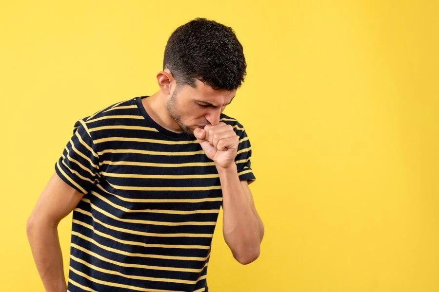 Man coughing into his hand